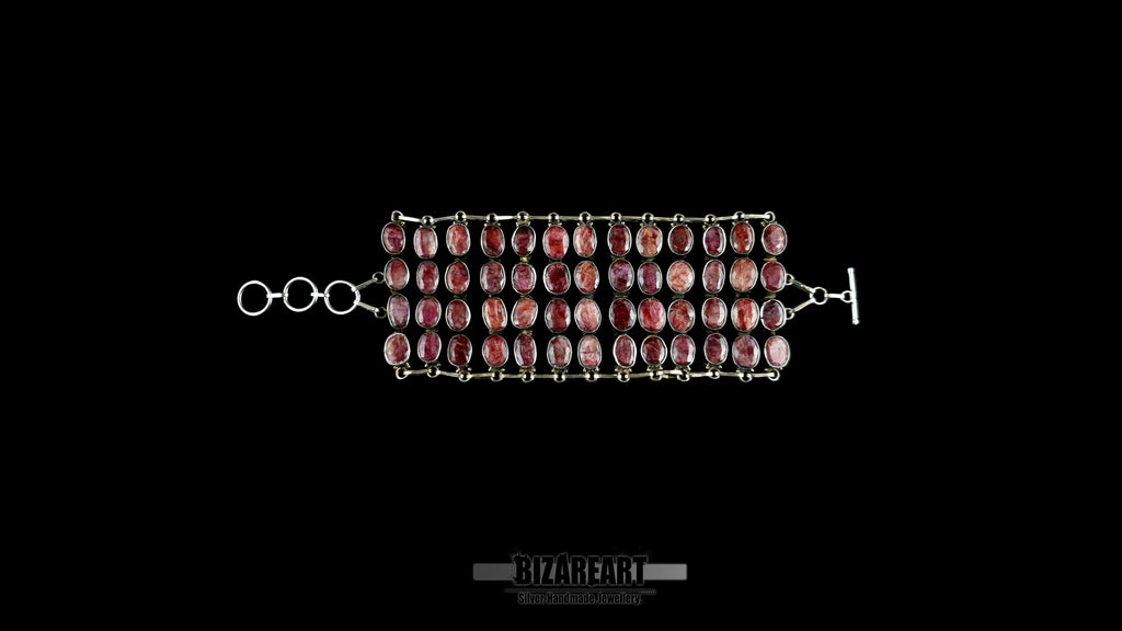 Flat lay view of 140g sterling silver ruby collar fully unrolled showing 3-ring extension chain and custom toggle closure.