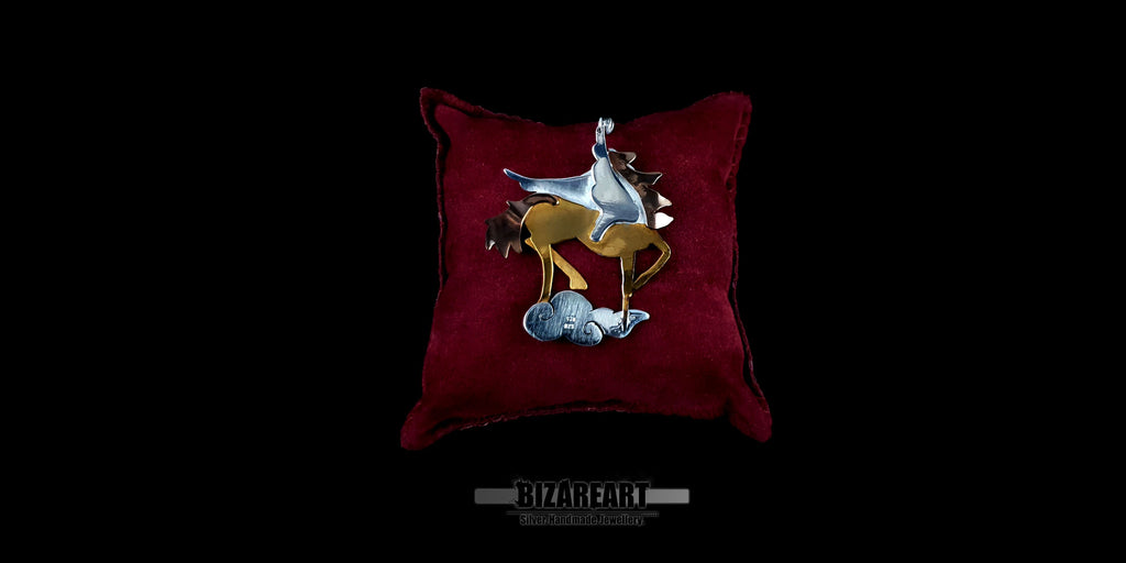 Detail shot of the Pegasus pendant's profile, showing the depth of the 3D mixed-metal layering and rose-gold plated tail.