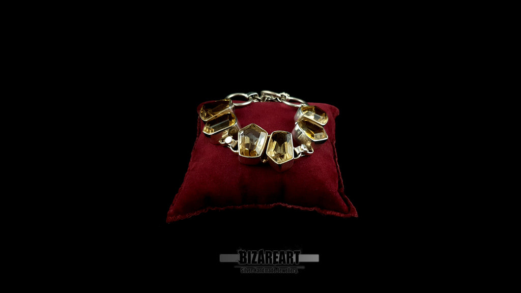 Handcrafted 925 sterling silver citrine bracelet looped on a luxury red velvet display pad