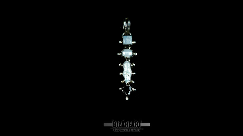 A front-facing view of the complete handcrafted sterling silver quad pendant, with its unique stack of four distinct gemstones: moonstone, pearl, and garnet, demonstrating its elegant vertical symmetry.