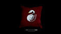 Handcrafted 3D silver swan pendant with multicolored enamel accents displayed on a luxury deep red velvet jewelry cushion.