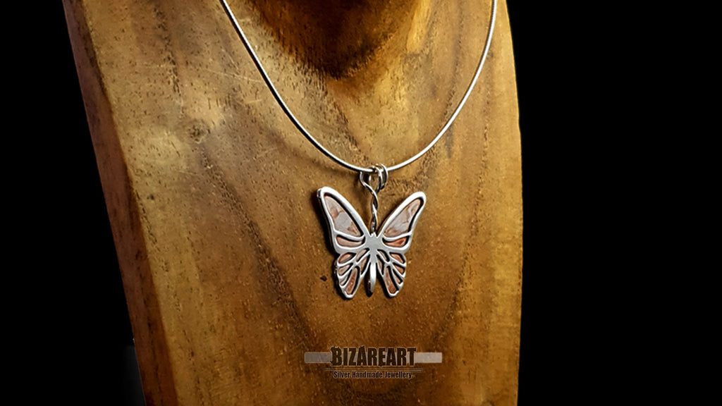 Detailed side profile of the Purple Emperor silver pendant showing the high-polish finish and filigree cells.