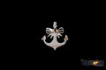 A high-resolution studio shot of the Anchor Pendant against a solid black background. The pendant features a polished 925 sterling silver anchor body topped with a delicate rose-plated copper bow and a central bi-color tourmaline gemstone.