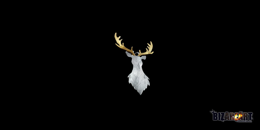 Three-quarter view of the deer pendant, illustrating the depth of the carved lines and the organic, layered silver textures.