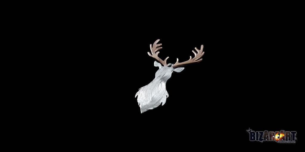 A three-quarter perspective view of the deer pendant, highlighting the sculptural depth of the antlers and the layered, organic texture of the silver deer head.