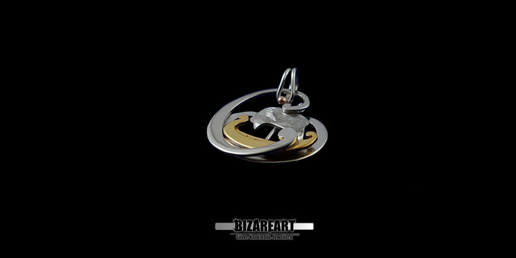 Direct view of the pendant's multi-tonal finish, showcasing the contrast between the polished silver and the textured gold elements.