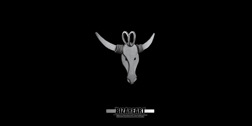 Textured sterling silver bull head pendant with wrapped horn details.