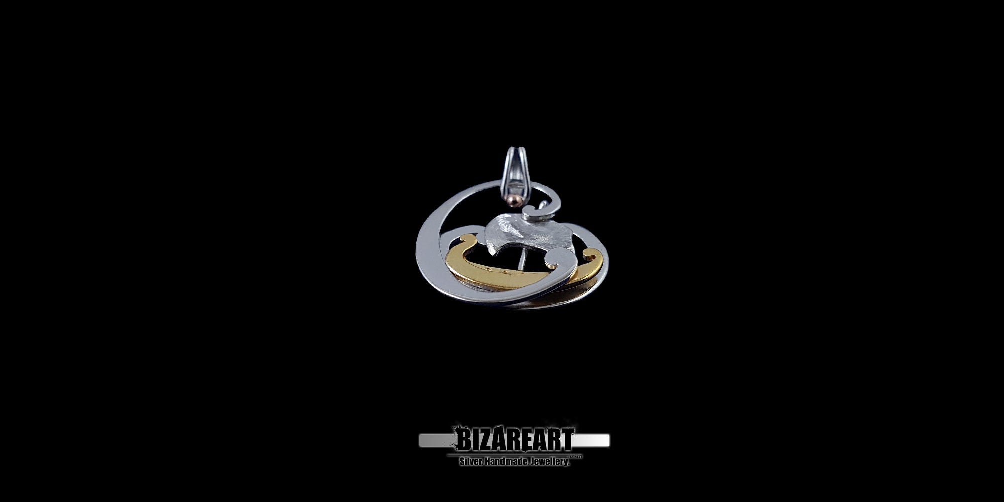 A three-quarter view of the Tiny Boat Pendant highlighting the 3D depth and the mixed-metal plating of the ship and the waves.