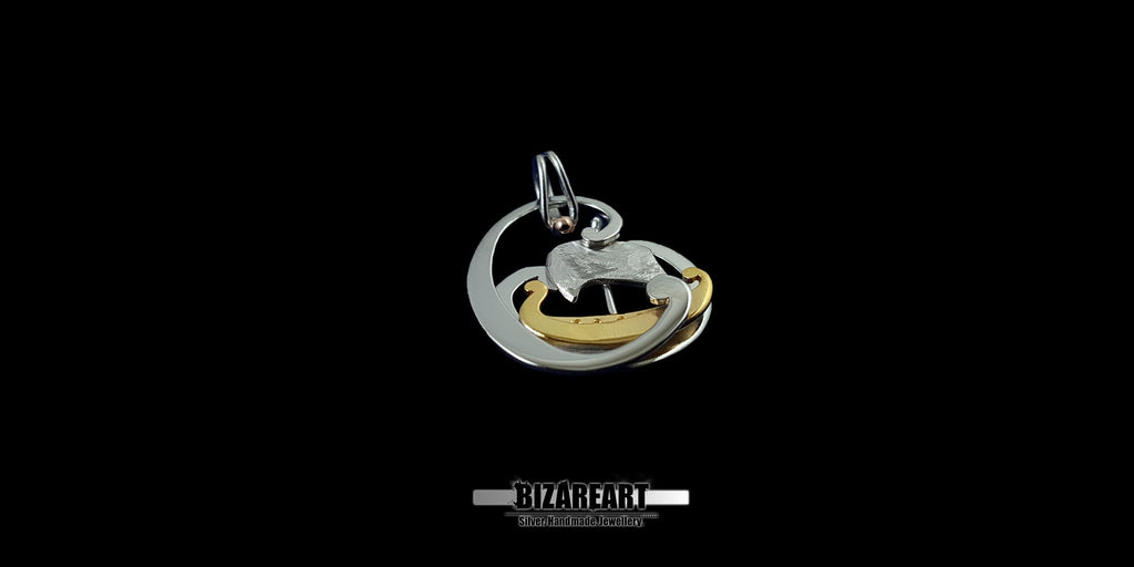 Close-up of the Tiny Boat Pendant showing the intricate detailing of the silver waves and the golden hull of the boat.