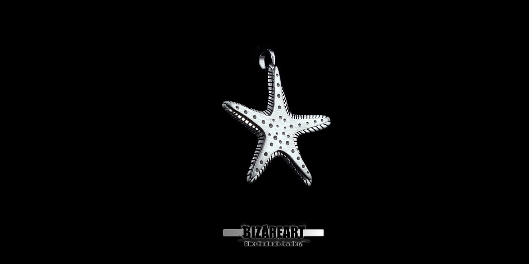 A wide-angle shot of the artisan starfish pendant showing its symmetrical design and thick, multi-layered silver construction.