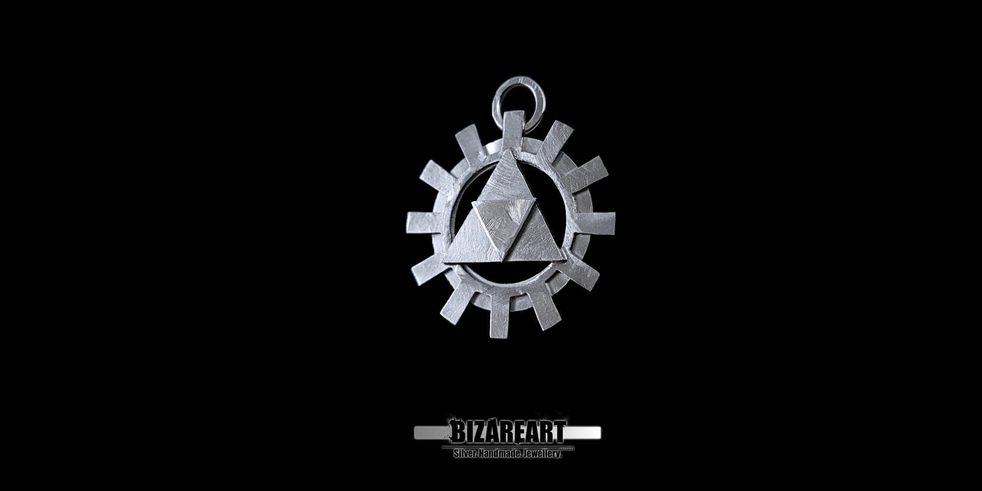 Front close-up view of a silver Triforce pendant with a gear-shaped border against a solid black background, showcasing the textured 3D layers and integrated top loop.