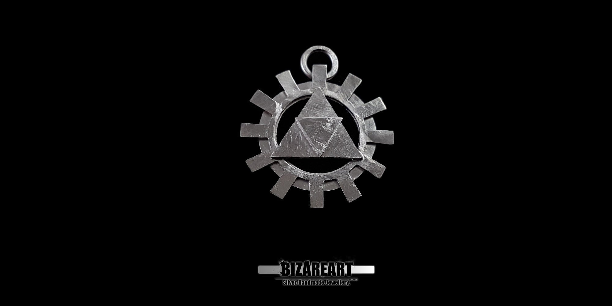 High-contrast front view of the silver Triforce emblem surrounded by a mechanical cog wheel, revealing the fine carved lines and scratched texturing.