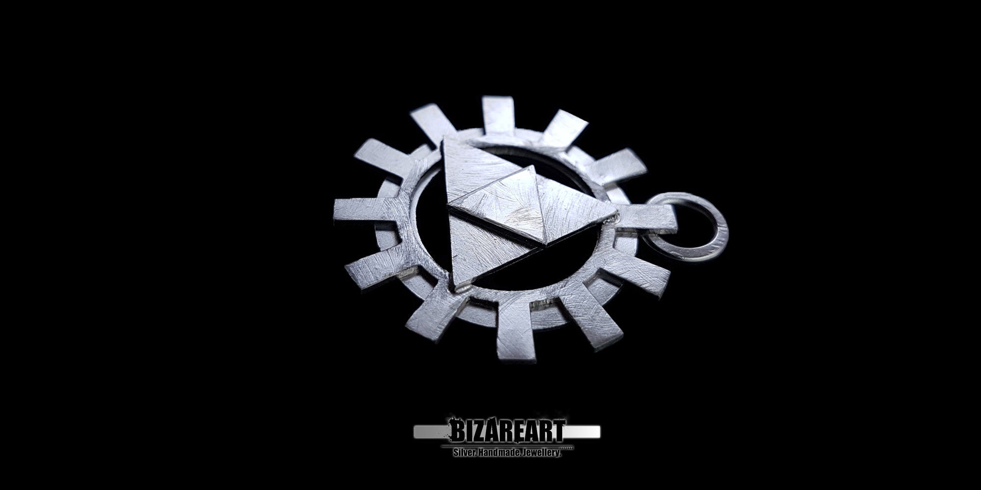 An angled close-up shot of the silver Zelda Triforce cog pendant, highlighting the thick, multi-layered construction and metallic shine against a black backdrop.