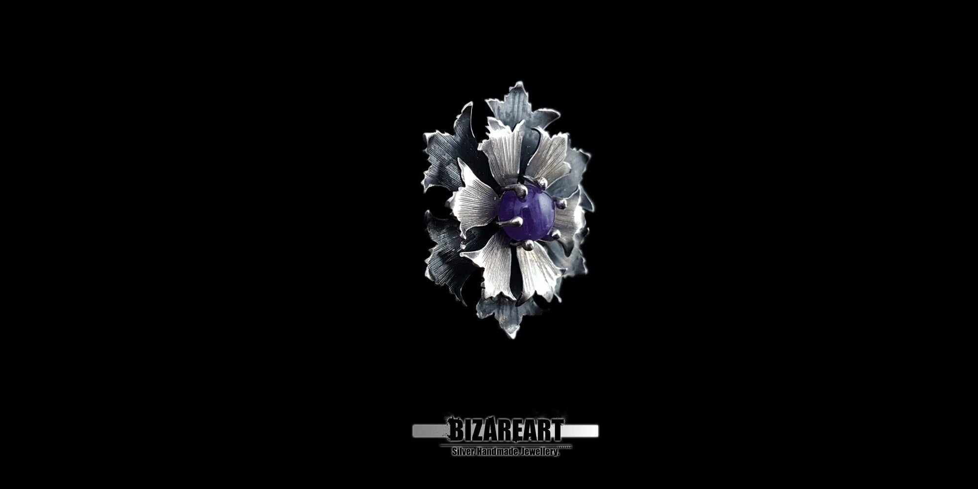 Angled side view of a dimensional, multi-layered silver flower pendant, showcasing its textured edge details and oxidized vintage finish.