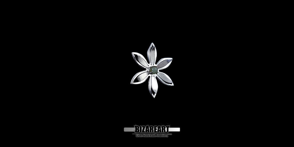 A series of product photography shots showing the silver flower pendant from various angles on a black background, highlighting the metallic sheen and the depth of the central gemstone.