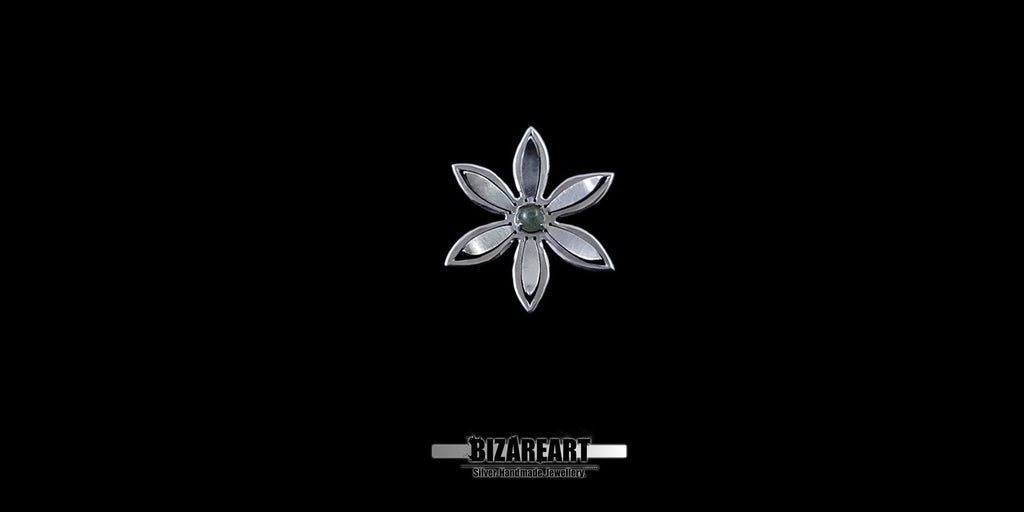 A series of product photography shots showing the silver flower pendant from various angles on a black background, highlighting the metallic sheen and the depth of the central gemstone.