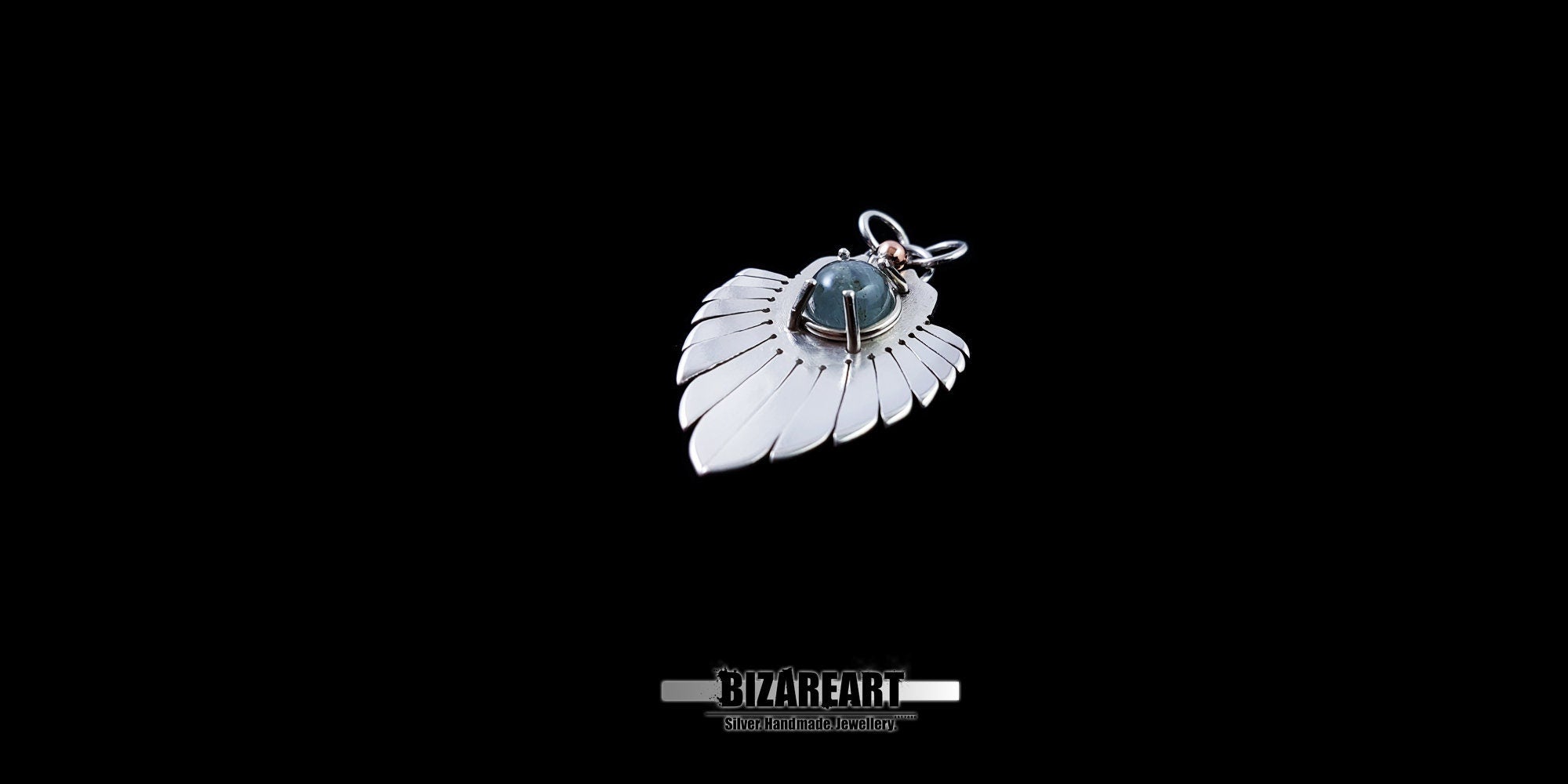 Side profile of the Silver Wings Pendant showing the secure claw setting and the light-catching cyan prisms of the Blue Tourmaline.