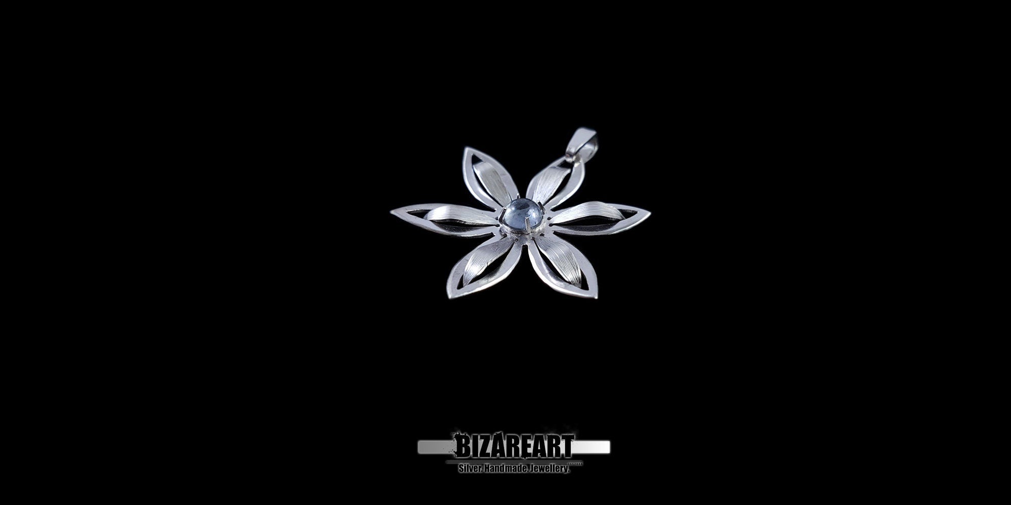 Close-up of a silver flower pendant showing the depth and texture of the handcrafted petals.