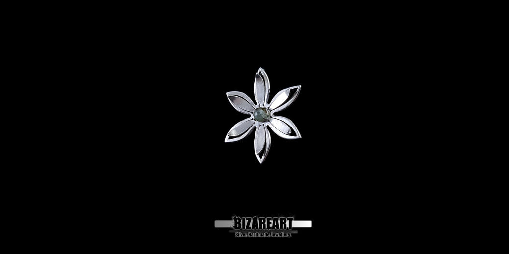 A series of product photography shots showing the silver flower pendant from various angles on a black background, highlighting the metallic sheen and the depth of the central gemstone.