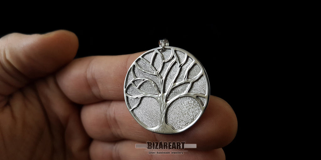 Close-up hand held of the dark oxidized silver background and polished tree branches