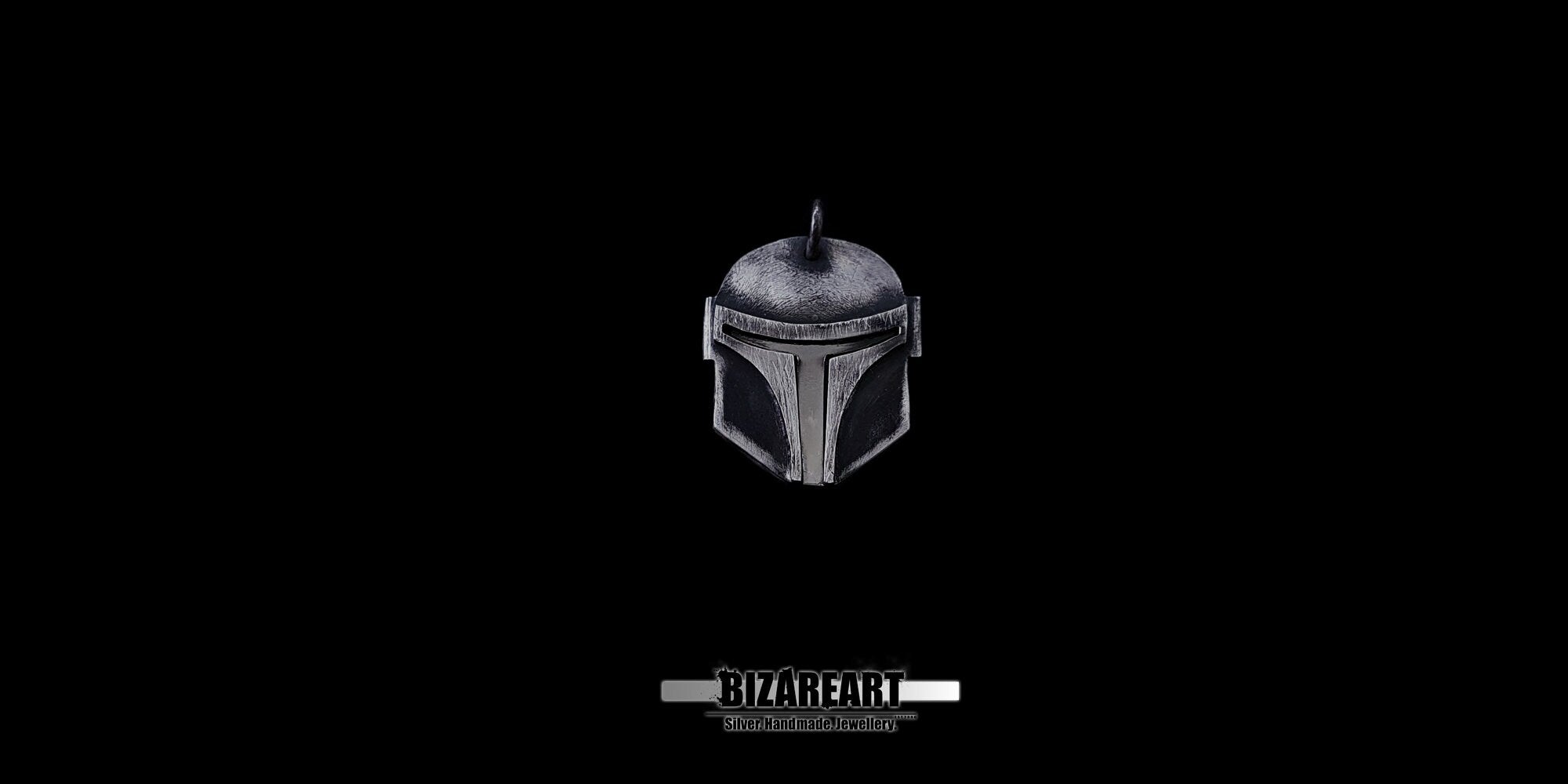 Front view of a handmade silver Mandalorian armor pendant featuring a detailed T-visor and battle-worn patina.
