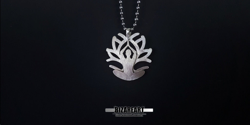 The pendant suspended on a chain, showing how the reinforced silver hanger sits naturally for daily wear.