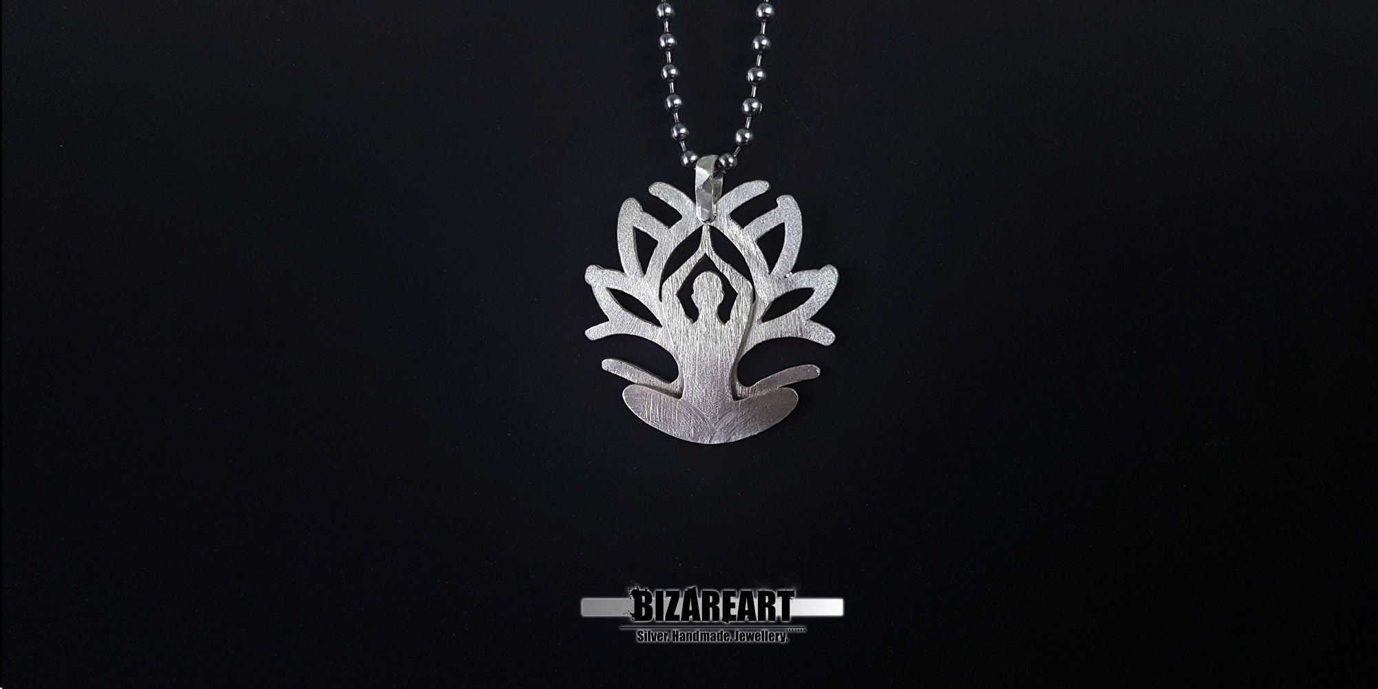 The pendant suspended on a chain, showing how the reinforced silver hanger sits naturally for daily wear.