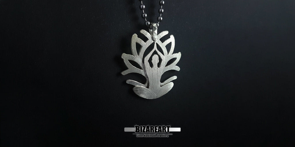 A close-up side angle of the pendant held in a hand, showcasing the "Inner Bloom" yoga figure integrated into the petal design.