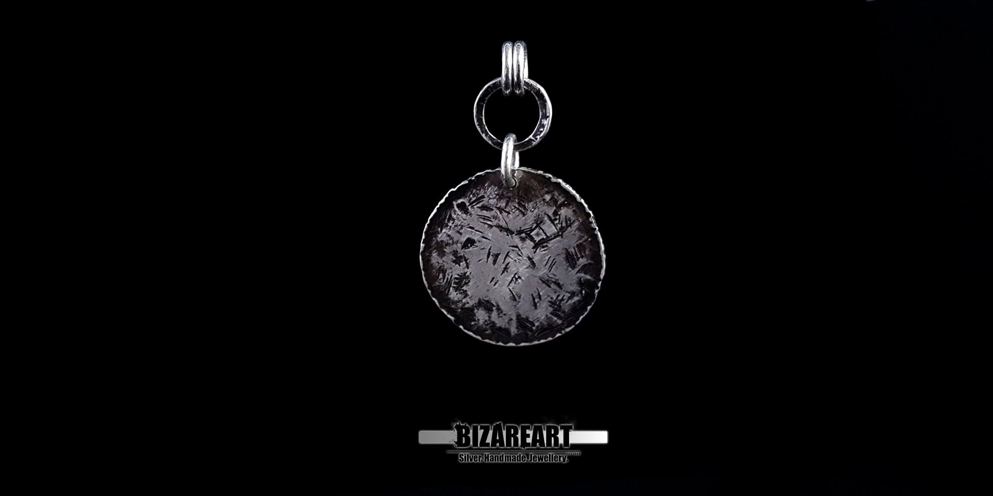 Reverse view of the Bromo Charm showing the rugged, textured oxidation and the secure soldered dual-loop silver rings.