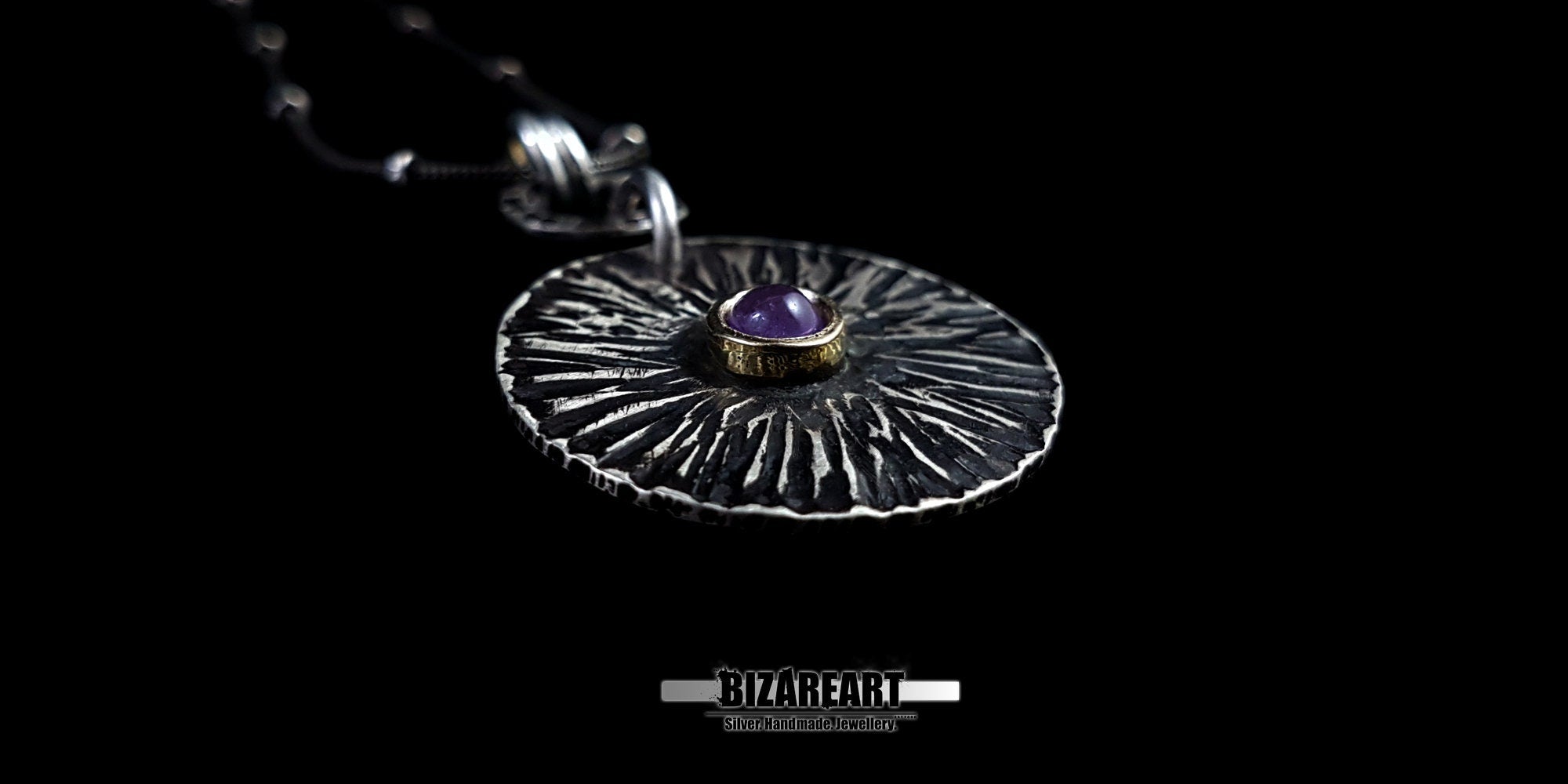 Close-up macro shot of the pendant's surface, detailing the contrast between the deep oxidized grooves and the polished silver ridges.