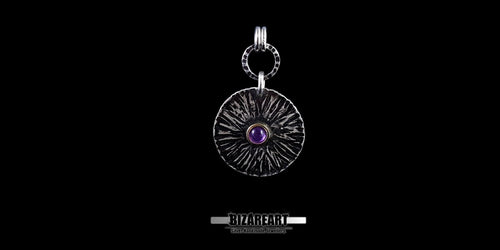 Front view of the Bromo Charm pendant featuring radial "Sea of Sand" etchings and a central amethyst stone set in a bronze bezel.