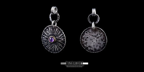 Two views of the Bromo Charm pendant side-by-side, showcasing the textured silver face with a purple amethyst gemstone and the rustic, oxidized reverse side.