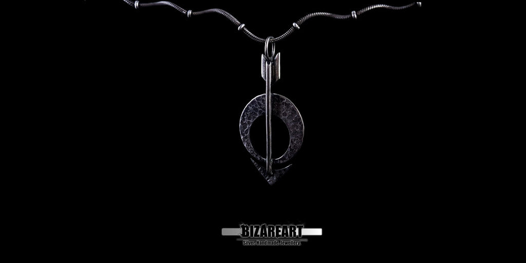 Frontal view of the Moon Arrow necklace showing the contrast between the shiny edges and oxidized silver surface.