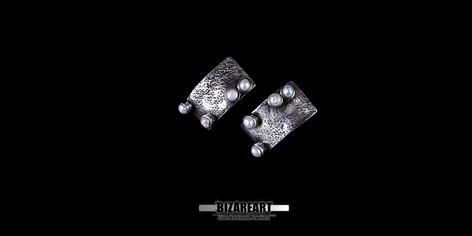Top-down perspective showing the multiple silver bezels holding the white pearls in place.