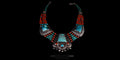 Symmetric front view of a vintage handmade Tibetan necklace featuring a large turquoise pendant, silver embellishments, and five strands of alternating red coral and turquoise beads.
