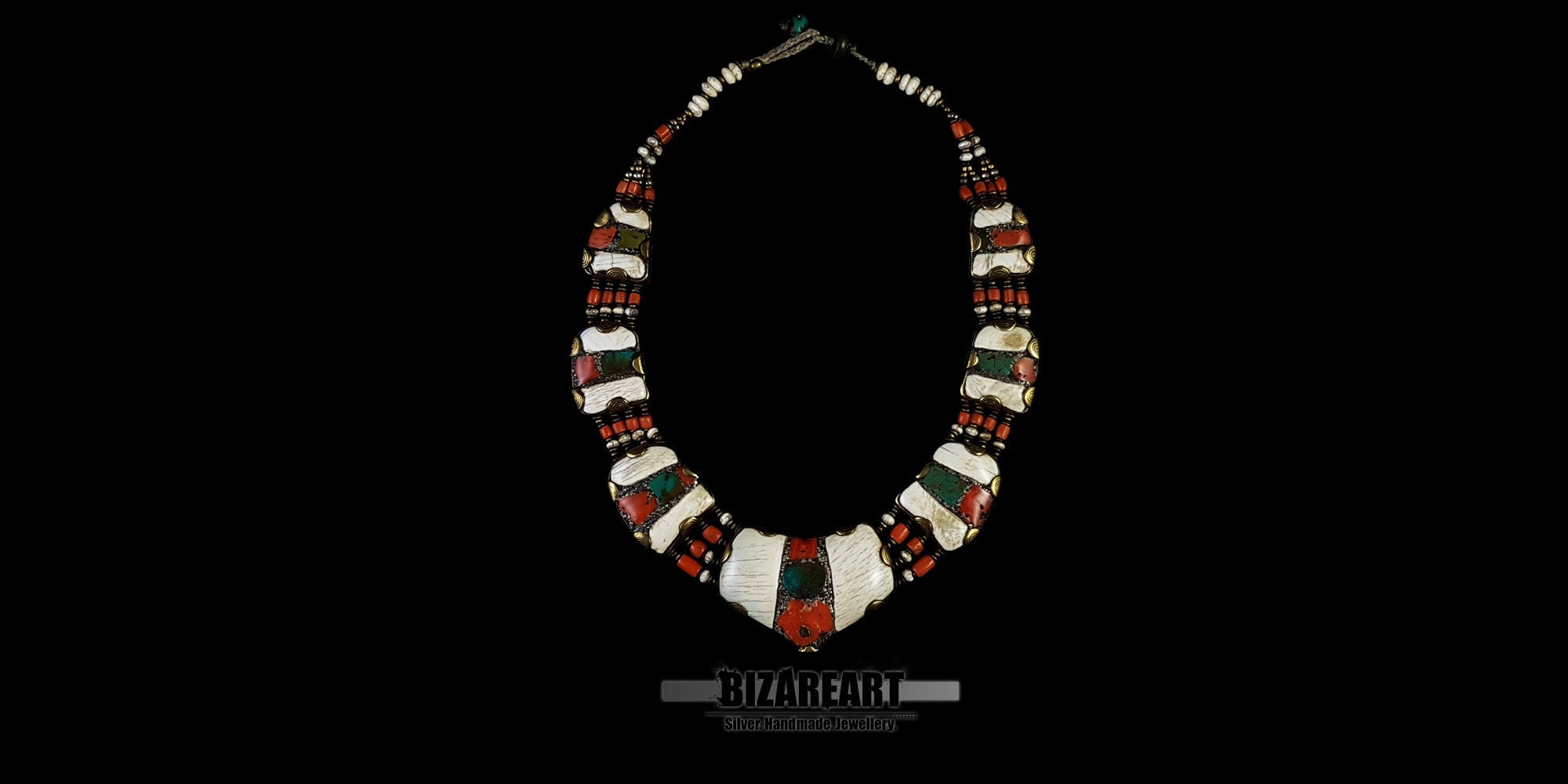 Full-length view of the handcrafted Nepalese necklace, showcasing the structured curvature, multi-strand coral beads, and the balance of contrasting gemstones.