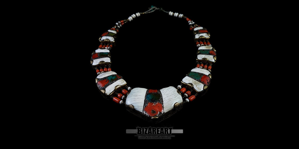 Symmetrical flat lay of the complete vintage Himalayan necklace, highlighting the repeating white conch shell panels inlaid with red coral and turquoise.