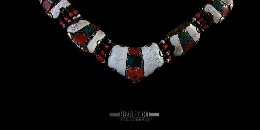 Close-up macro shot of the centerpiece pendant, showing the texture of the white Tibetan conch shell, inlaid turquoise, red coral stones, and detailed bronze borders.