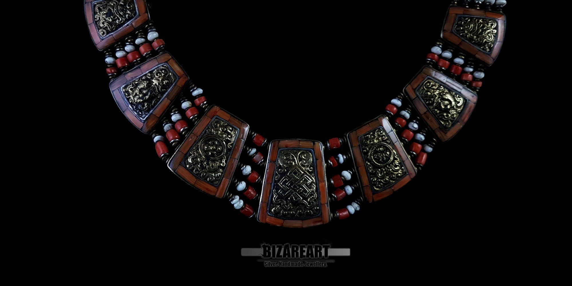 Macro view of the central bronze pendant plates and red coral details on the vintage Nepalese statement necklace.