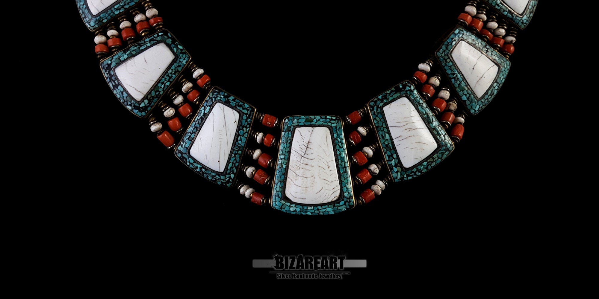 Close-up of a vintage Nepalese necklace detailing inlaid white Tibetan conch shell plaques framed by turquoise beads and red coral accents.