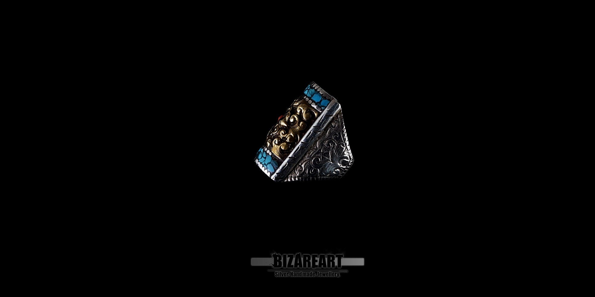 Close-up of the ornate bronze centerpiece on a handcrafted Tibetan ring, highlighting the textured metalwork and mosaic gemstone inlay.