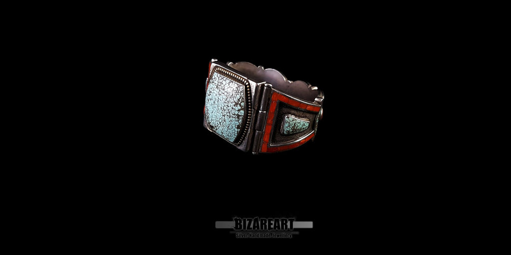 Angled close-up of the bracelet showing the opposite (right) side of the central stone and the detailed red coral panel. The texture and matrix of the large turquoise are clearly visible against the black backdrop.