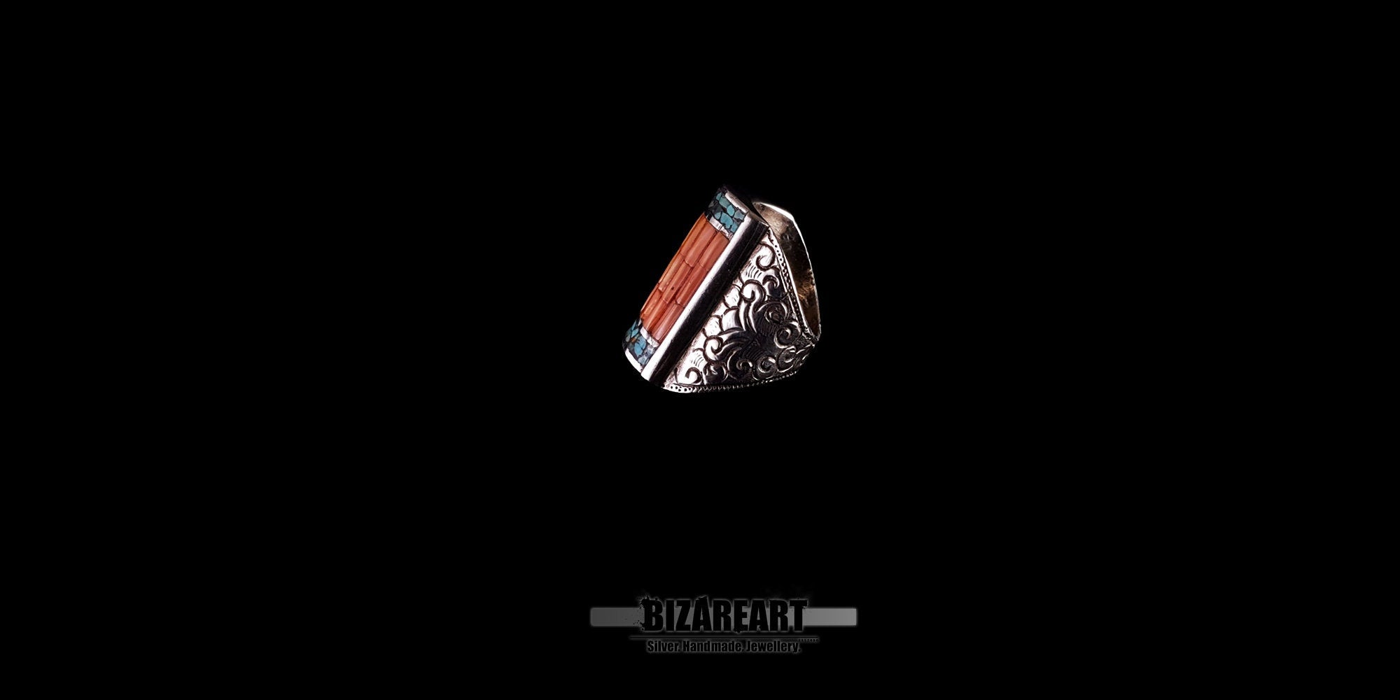 Alternative side angle of the Tibeto-Nepalese silver ring, showing how the turquoise and coral gemstones sit securely within the engraved silver setting.