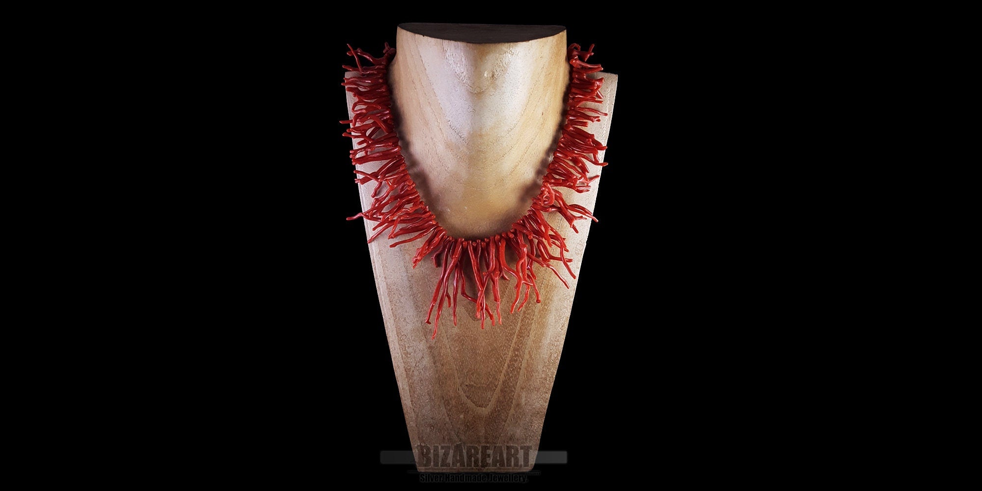 Handmade red coral branch necklace styled on a jewelry display bust to show fit and scale
