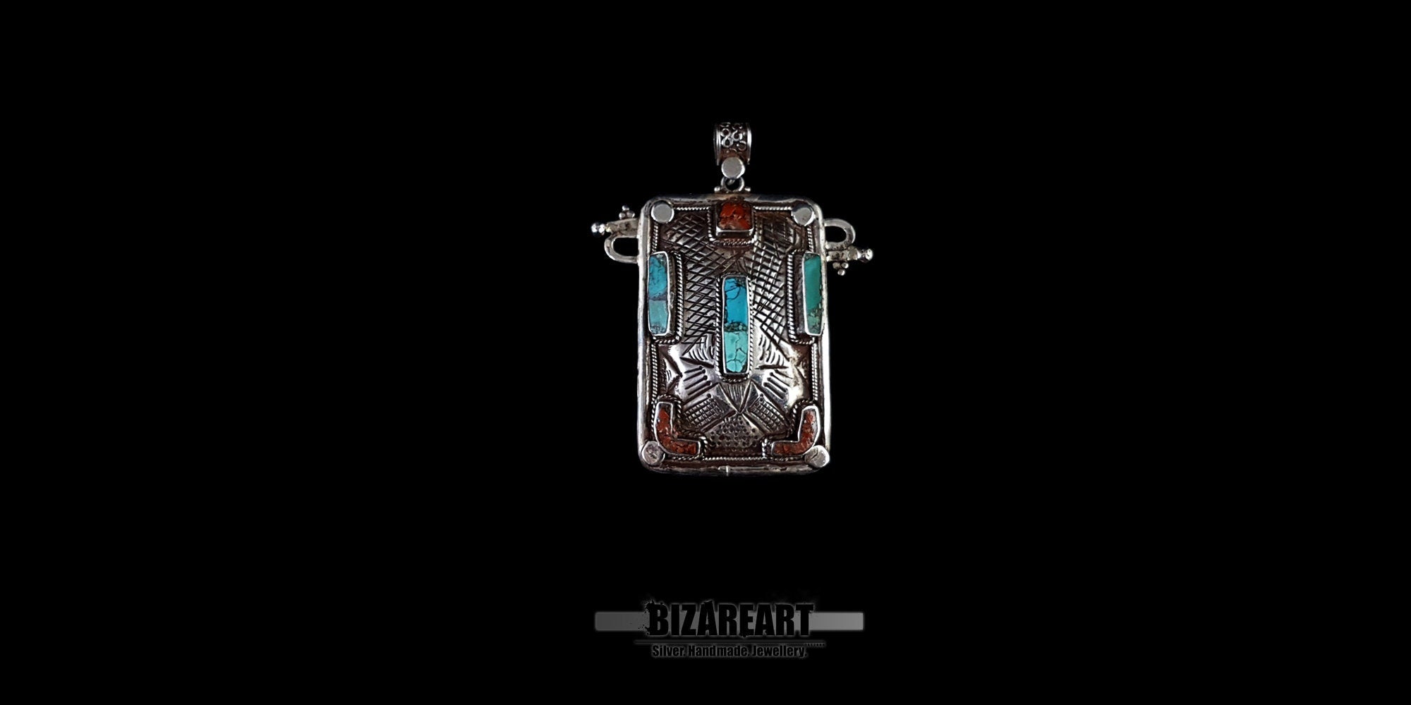 Handcrafted Himalayan silver pendant with turquoise and red coral gemstones on a black background - BIZAREART jewelry.