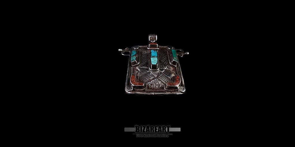 top down view of the hammered sterling silver texture and genuine Himalayan turquoise settings on a collectible pendant.