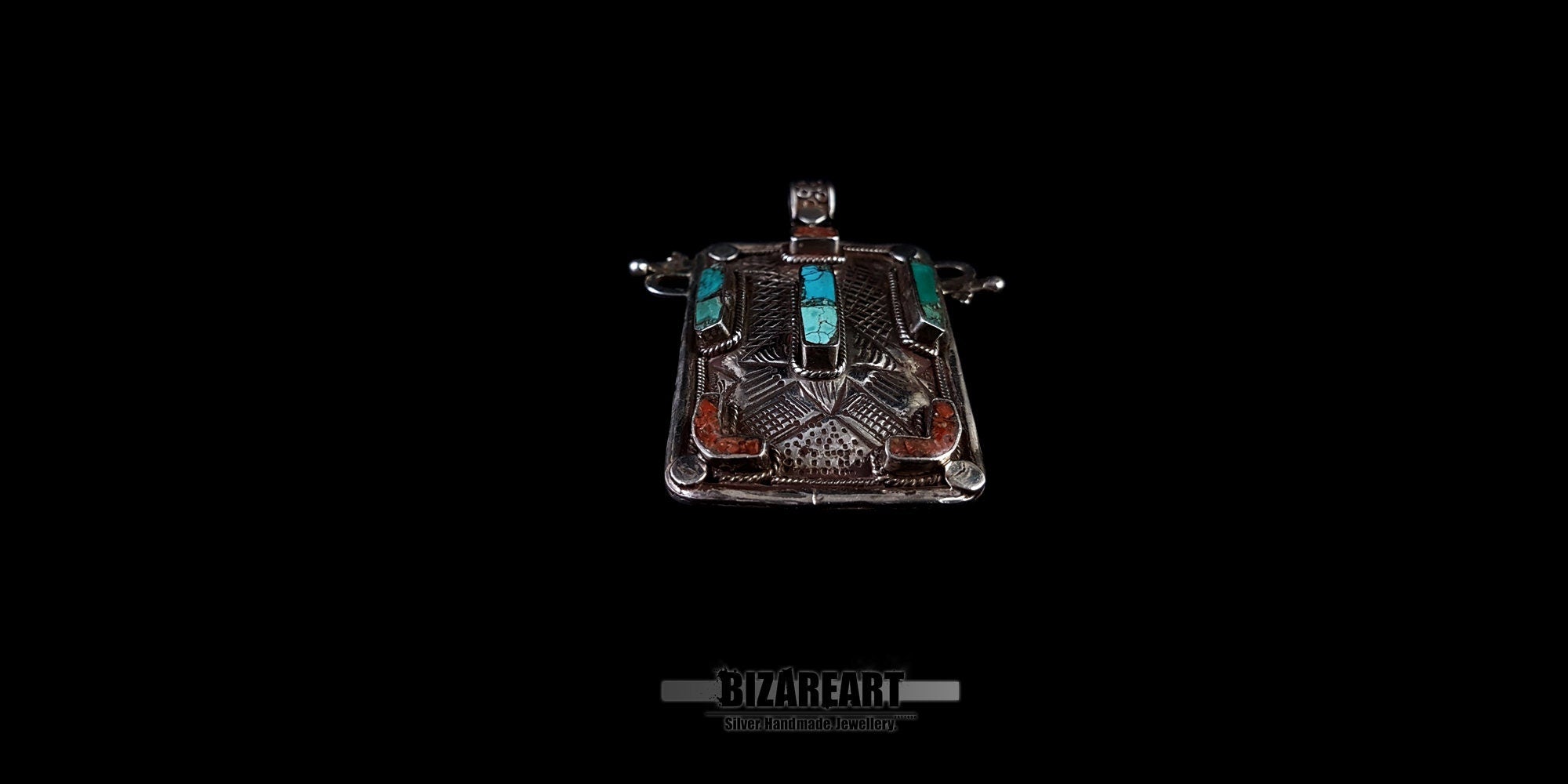 top down view of the hammered sterling silver texture and genuine Himalayan turquoise settings on a collectible pendant.