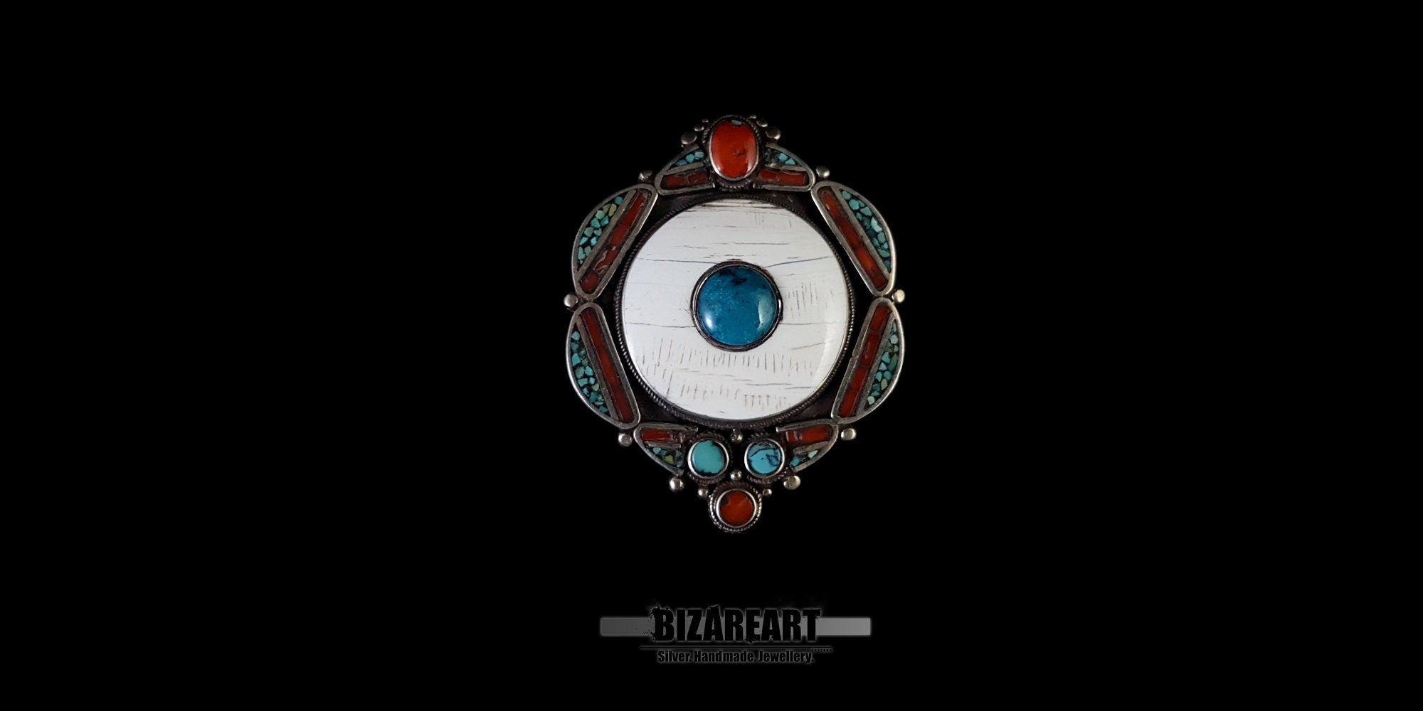 Front view of a large vintage Tibetan silver pendant featuring a central white conch shell cabochon inlaid with a turquoise gemstone.