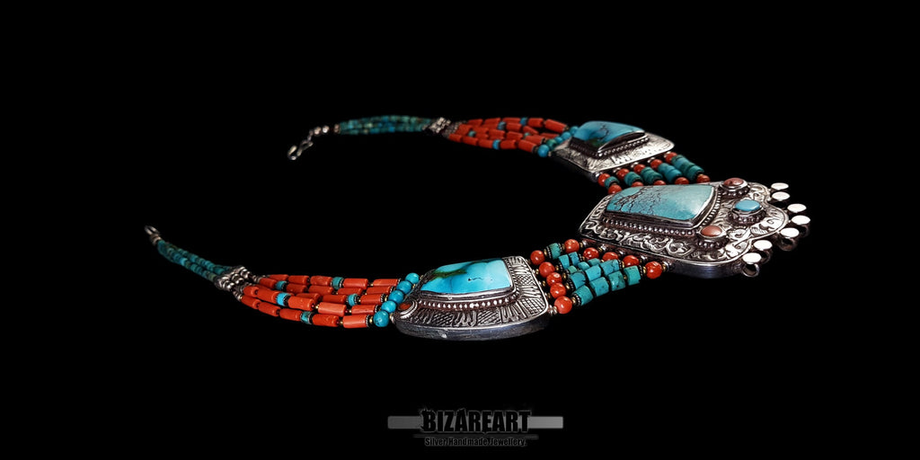 Extreme close-up of the traditional silver Tibetan Turquoise Box pendant, highlighting the raised bezel setting and inlaid coral accents.
