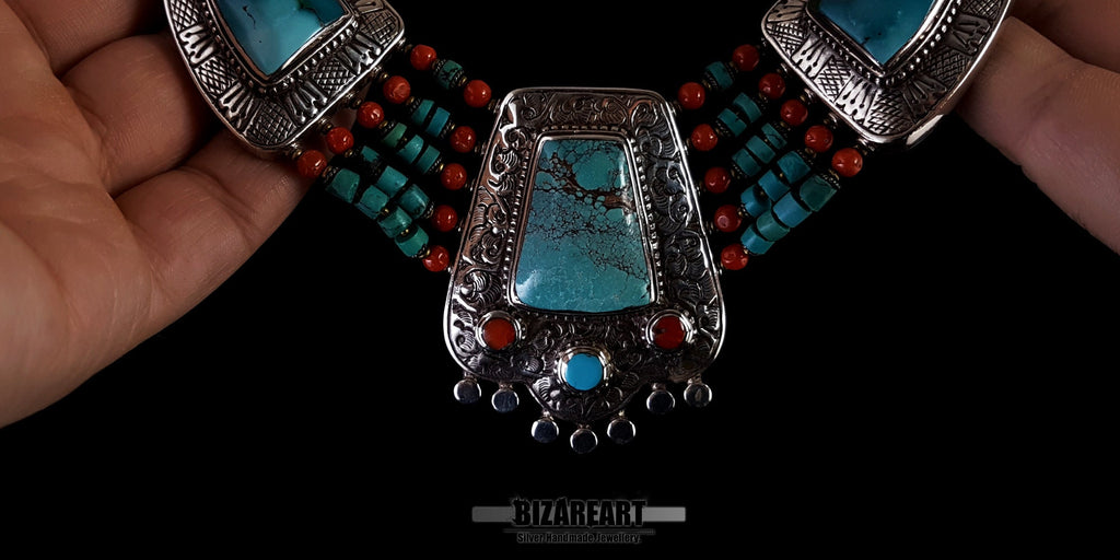 Three-quarter perspective view of the vintage Nepalese necklace showcasing the dramatic transition from the coral strands to the silver bail.